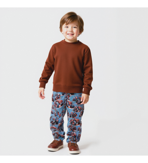 Waterdichte broek voor jongens met tractorprint in het rood.